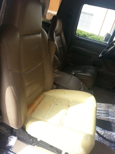 1994 Ford Bronco - Interior view of car seats with visible foam padding and a center console.