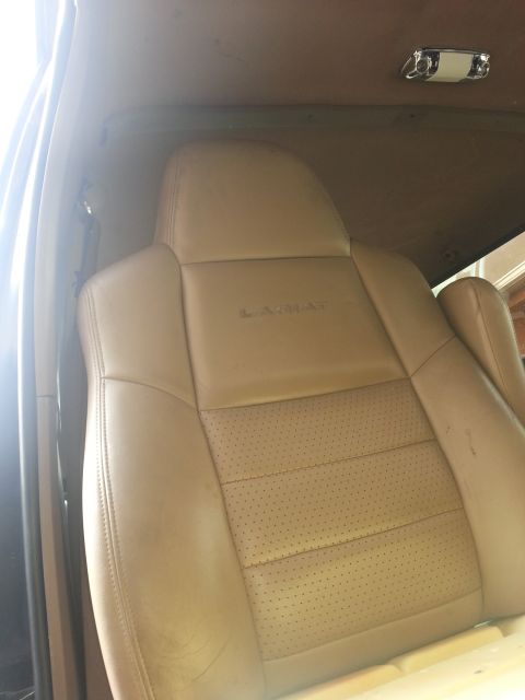 1994 Ford Bronco - Interior car seat detail, showing perforated leather and embossed text on the headrest.