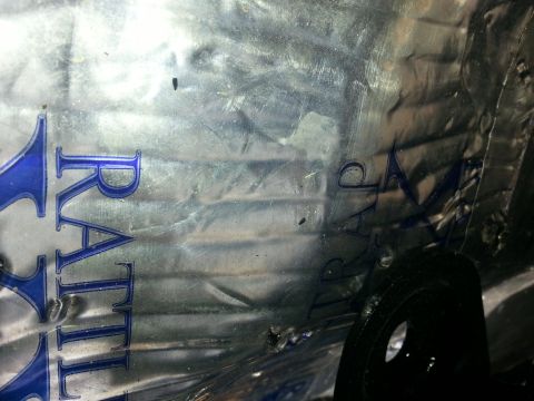 1994 Ford Bronco - Shiny metal part with partial text and handwritten markings visible.