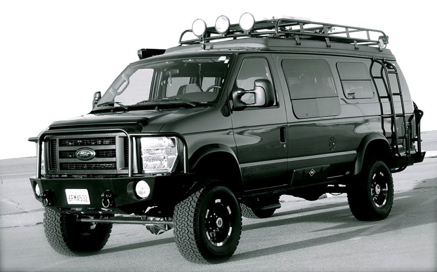 Black Ford E-Series van with off-road modifications, roof rack, and ladder