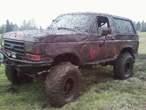 1989 Ford Bronco - This heavily mud-caked Ford Bronco appears to be from the late 1980s, with its grille and body style suggesting a 1987 model year.