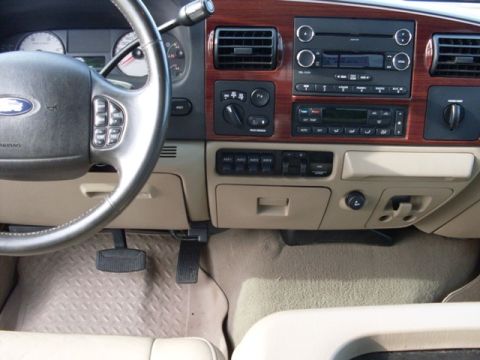 1995 Ford F-150 - Dashboard interior with wood grain accents and auxiliary switches. Supermotors.net logo is present.