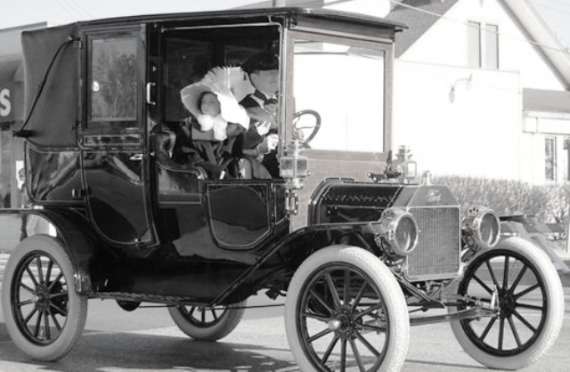 1912 Ford Model T town car with passengers inside