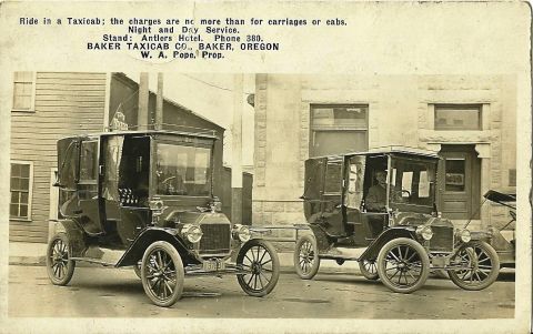 1912 Ford Model T - Baker, Oregon taxicab company advertises its services with two Ford Model T town cars, circa 1912.