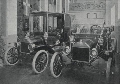 1912 Ford Model T - Two early automobiles, likely Ford Model Ts, are parked indoors.