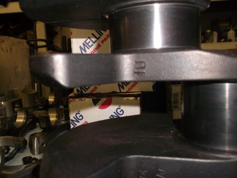 1967 Ford Mustang - Close-up of a crankshaft with "10U" stamped on it, Melling engine parts boxes visible.