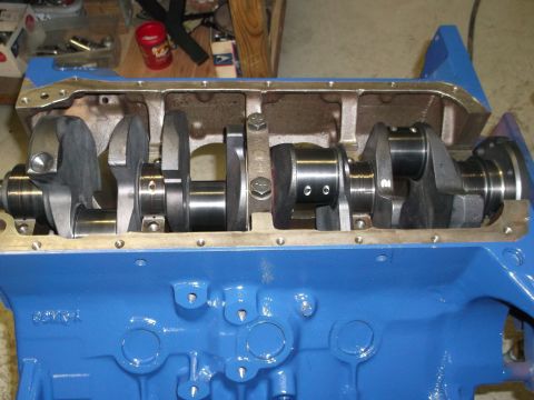 1967 Ford Mustang - The internal components of an engine are visible, including the crankshaft and connecting rods within the block.