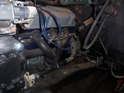 1968 Ford Bronco - Close-up view of engine components, including exhaust manifolds and blue valve covers, likely part of a custom build or upgraded system.