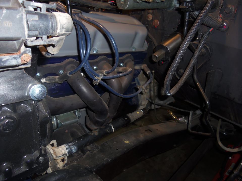 Engine bay with blue valve covers and exhaust manifolds
