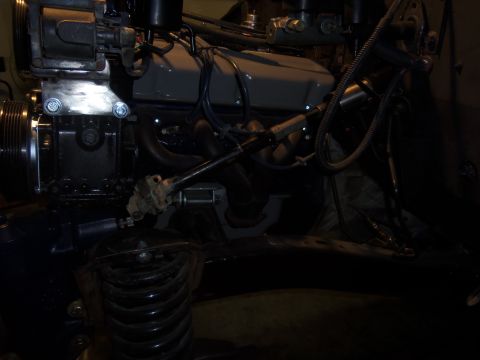 1968 Ford Bronco - Close-up view of engine bay components, including steering linkage and exhaust manifold.