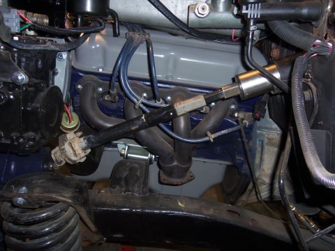1968 Ford Bronco - Close-up view of an engine bay, focusing on the exhaust manifold and associated components.