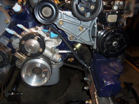 1968 Ford Bronco - Close-up view of engine components, including a water pump and power steering pump.