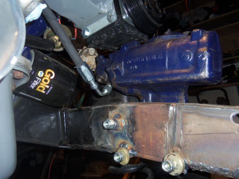 1968 Ford Bronco - A close-up view shows a blue power steering gearbox and an oil filter installed on a vehicle's frame.