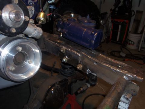 1968 Ford Bronco - This photo shows a vehicle's frame undergoing a steering upgrade, a newly installed steering box and engine components.
