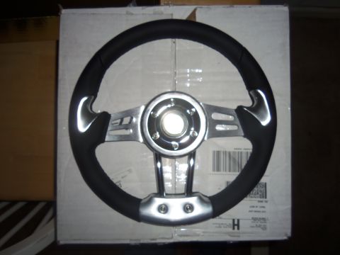 1968 Ford Bronco - Aftermarket steering wheel with black grip and chrome spokes, likely for a custom build.