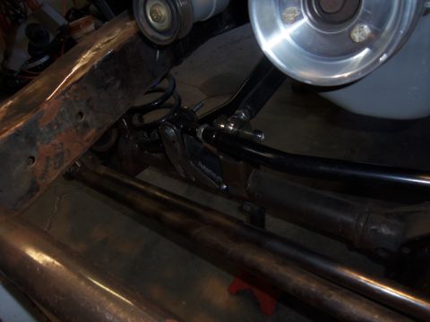 1968 Ford Bronco - Undercarriage view of vehicle suspension components, with visible rust on the frame.