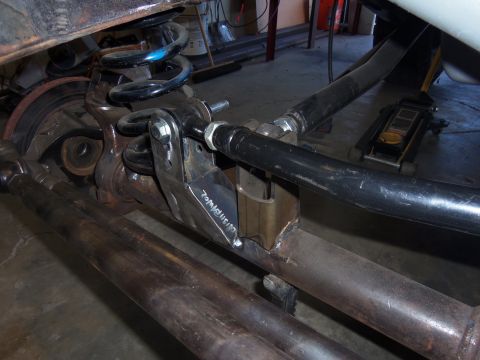 1968 Ford Bronco - Close-up of a custom-welded trac bar mount on a vehicle's rear axle housing, showing suspension components.
