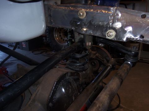 1968 Ford Bronco - Close-up of a Ford Bronco's rear axle and suspension components, showing frame modifications.
