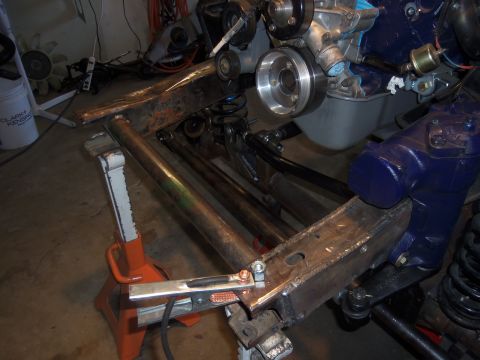 1968 Ford Bronco - Close-up of vehicle frame and engine assembly during repair or modification.