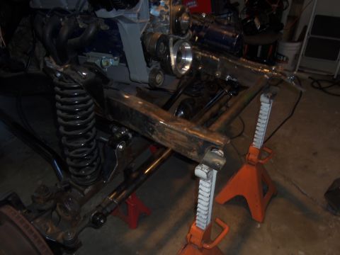 1968 Ford Bronco - Close-up view of a vehicle's frame and engine assembly, supported by jack stands.