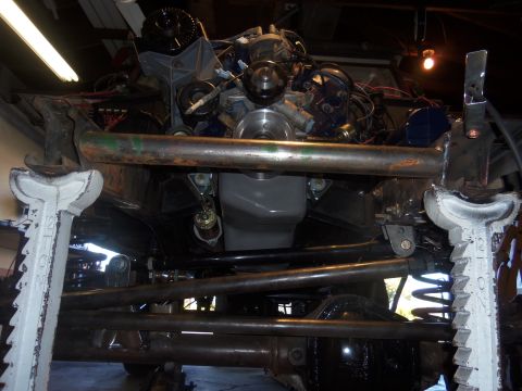 1968 Ford Bronco - Underside view of engine and suspension components, possibly a Ford Bronco, undergoing work.