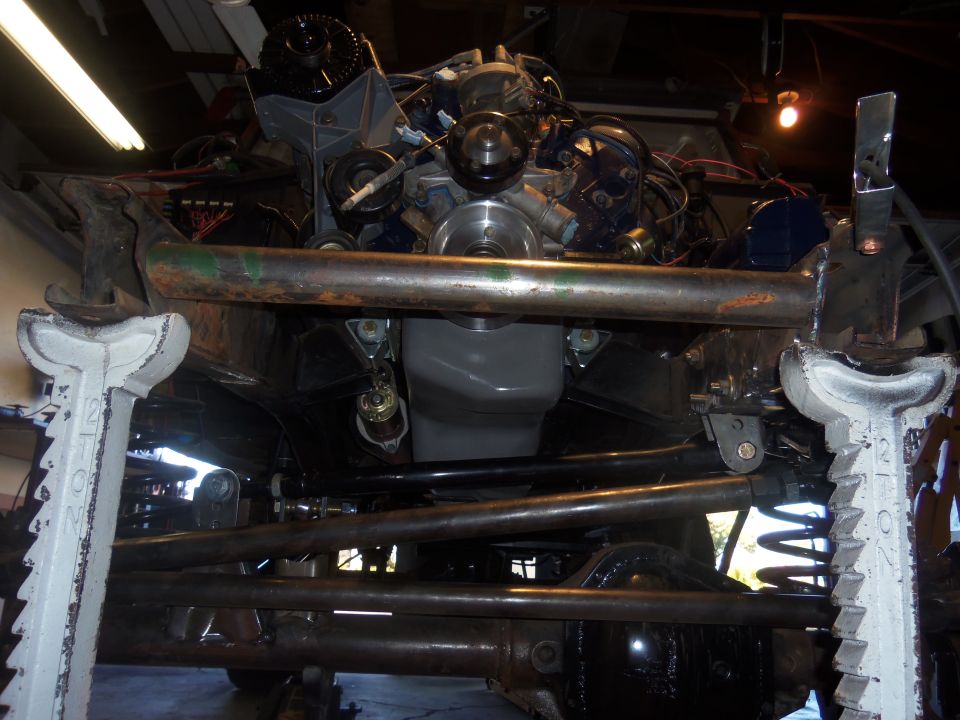 Underside view of engine and suspension components on a vehicle