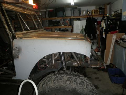 1961 International Scout 800 - A vehicle in a garage appears to be undergoing significant modifications and restoration.
