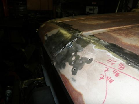 1961 International Scout 800 - Body panel undergoing repair, showing welding marks and handwritten measurements for bodywork.