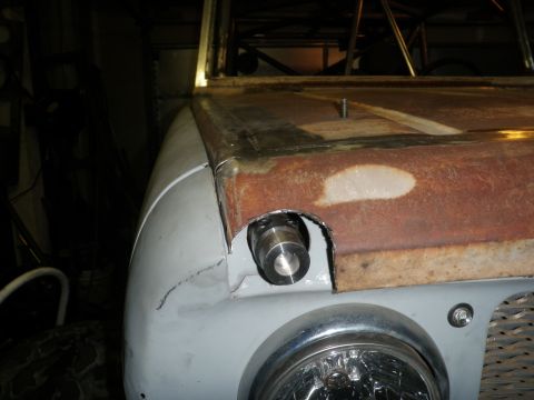 1961 International Scout 800 - The vehicle's body is in a state of repair, with primer applied to the fender and rust visible on the hood.