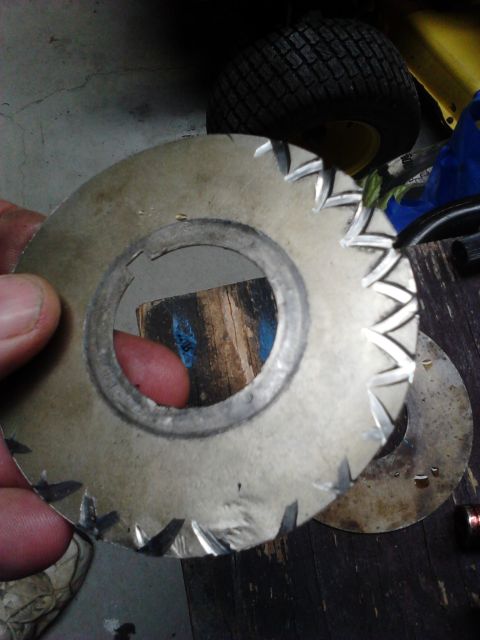 1979 Ford Ranchero - A serrated metal washer is held up, with a lawn mower tire visible in the background.