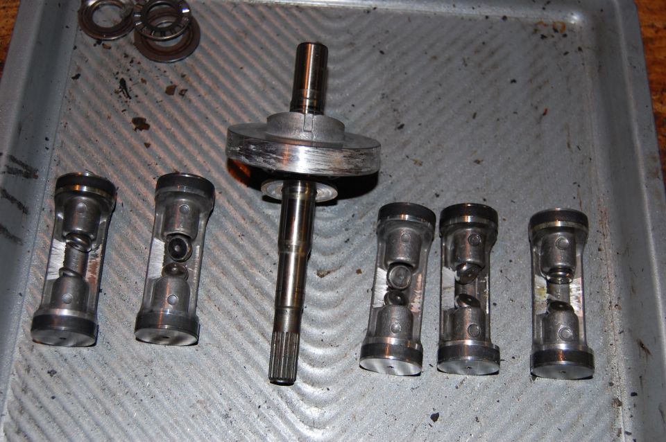 Swash plate and pistons. Note the extensive damage to the swash plate and all pistons.
