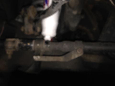 1996 Ford Bronco - Underside view of a vehicle's steering linkage system.