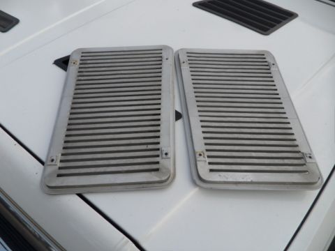 1994 Jeep Cherokee - Two vent covers are shown on a white surface, with a black vent cover in the background.