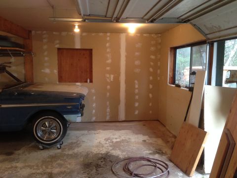 1964 Ford Fairlane - A blue 1964 Ford Fairlane is parked in a garage with unfinished walls.