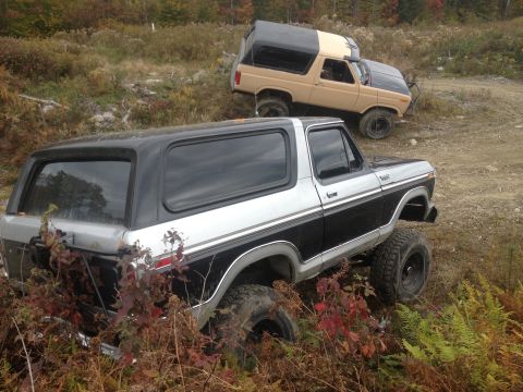 1970 Ford F-250 - Two Ford Broncos are parked on an off-road trail during the fall season.
