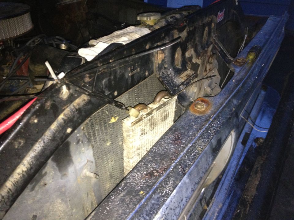 1970 Ford F-250 engine bay with radiator and grille. Blue paint visible