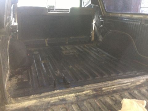 1970 Ford F-250 - The interior of a truck bed is shown, with visible floor ribs and side panels.