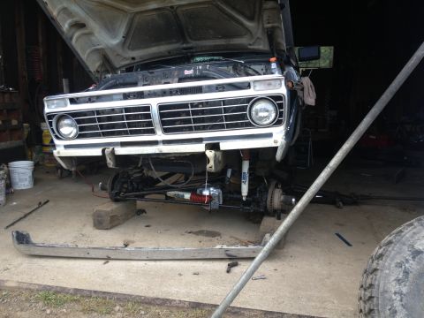 1970 Ford F-250 - Front view of a 1970 Ford F-250 truck with its hood up and bumper detached for service.