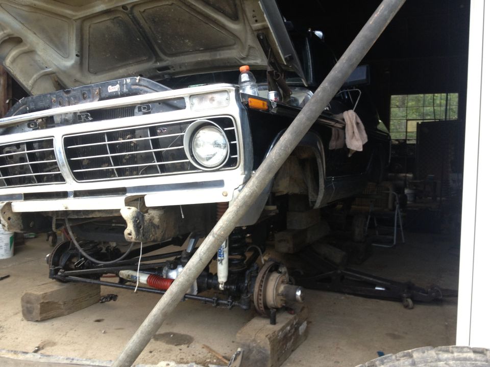 1973 Ford F-Series truck front end, hood open, undergoing repairs, raised on blocks