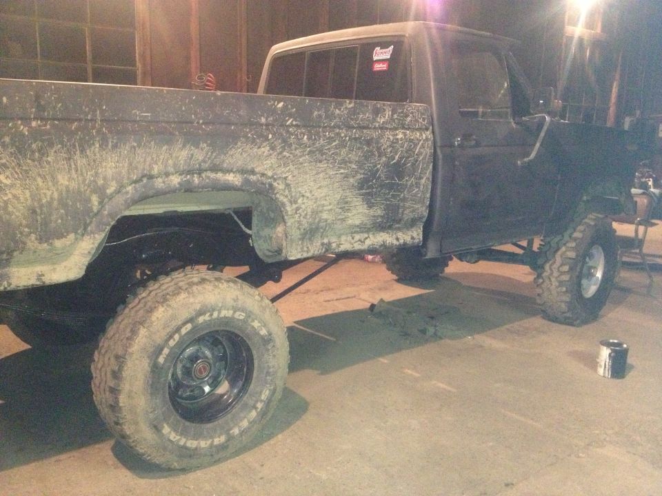 Side view of a 1970 Ford F-250 with mud splatter and lifted suspension