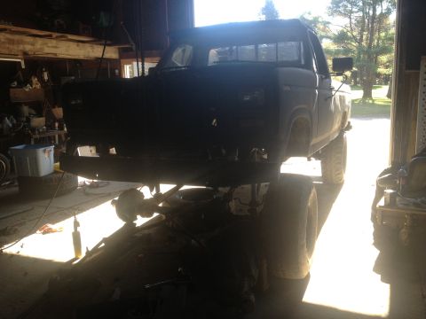 1970 Ford F-250 - Front view of a 1970 Ford F-250 truck chassis undergoing work in a garage.