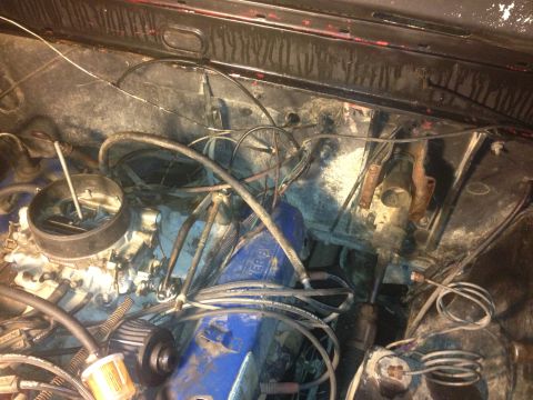 1970 Ford F-250 - Close-up view of the engine bay of a 1970 Ford F-250, showing the carburetor and blue valve covers.
