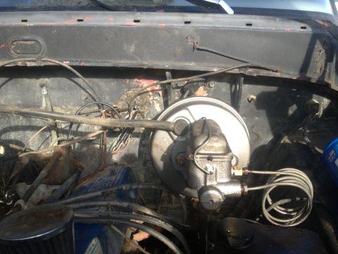 1970 Ford F-250 - Close-up of the brake booster and master cylinder assembly in a vehicle's engine bay.