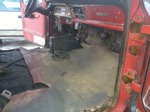 1970 Ford F-250 - The interior of a 1970 Ford F-250 shows the dashboard, steering wheel, and floor, with the carpet removed.