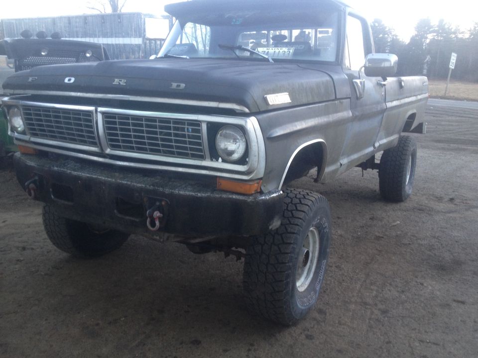 Ford pickup truck, front end visible, lifted suspension, off-road tires