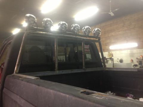 1970 Ford F-250 - Rear view of a truck with a custom rack and skull lights mounted above the cab.