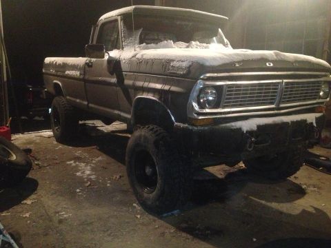 1970 Ford F-250 - This lifted 1970 Ford F-250 is seen in a garage with snow covering its exterior.