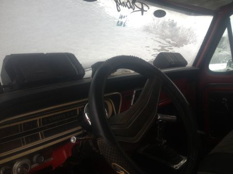 1970 Ford F-250 - Interior view of a 1970 Ford F-250, a dashboard and steering wheel with an icy windshield.