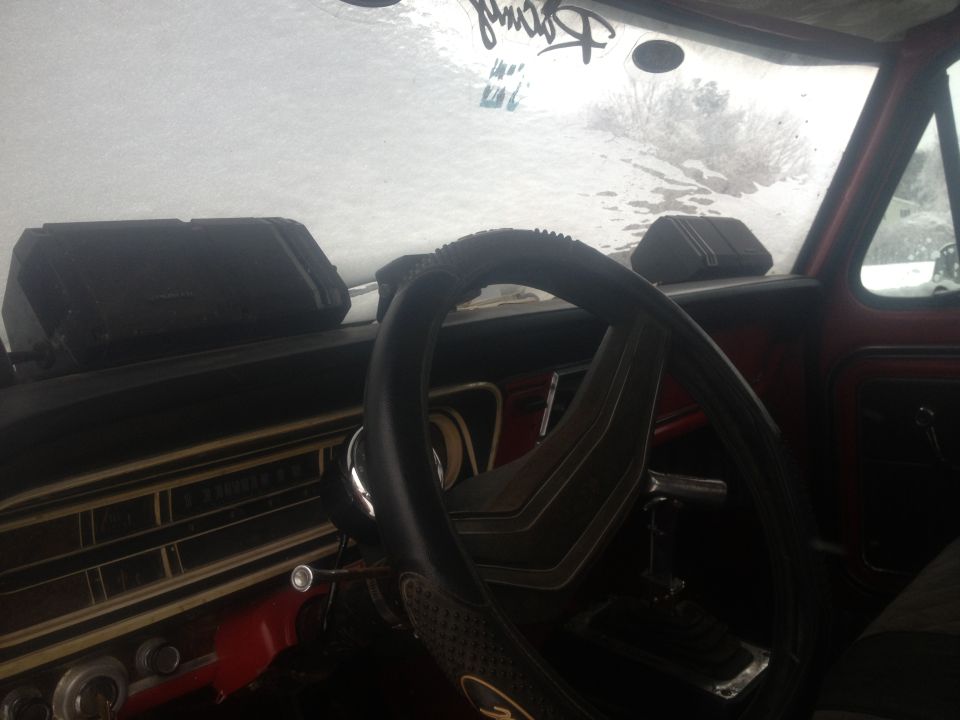 1970 Ford F-250 interior showing dashboard, steering wheel, and windshield with ice
