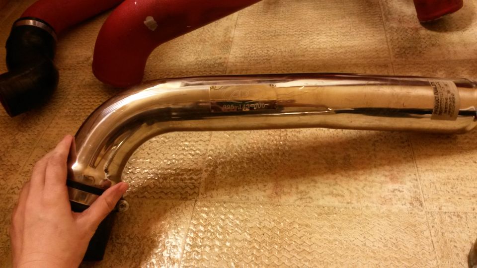 Chrome exhaust pipe with a label and a hand holding it
